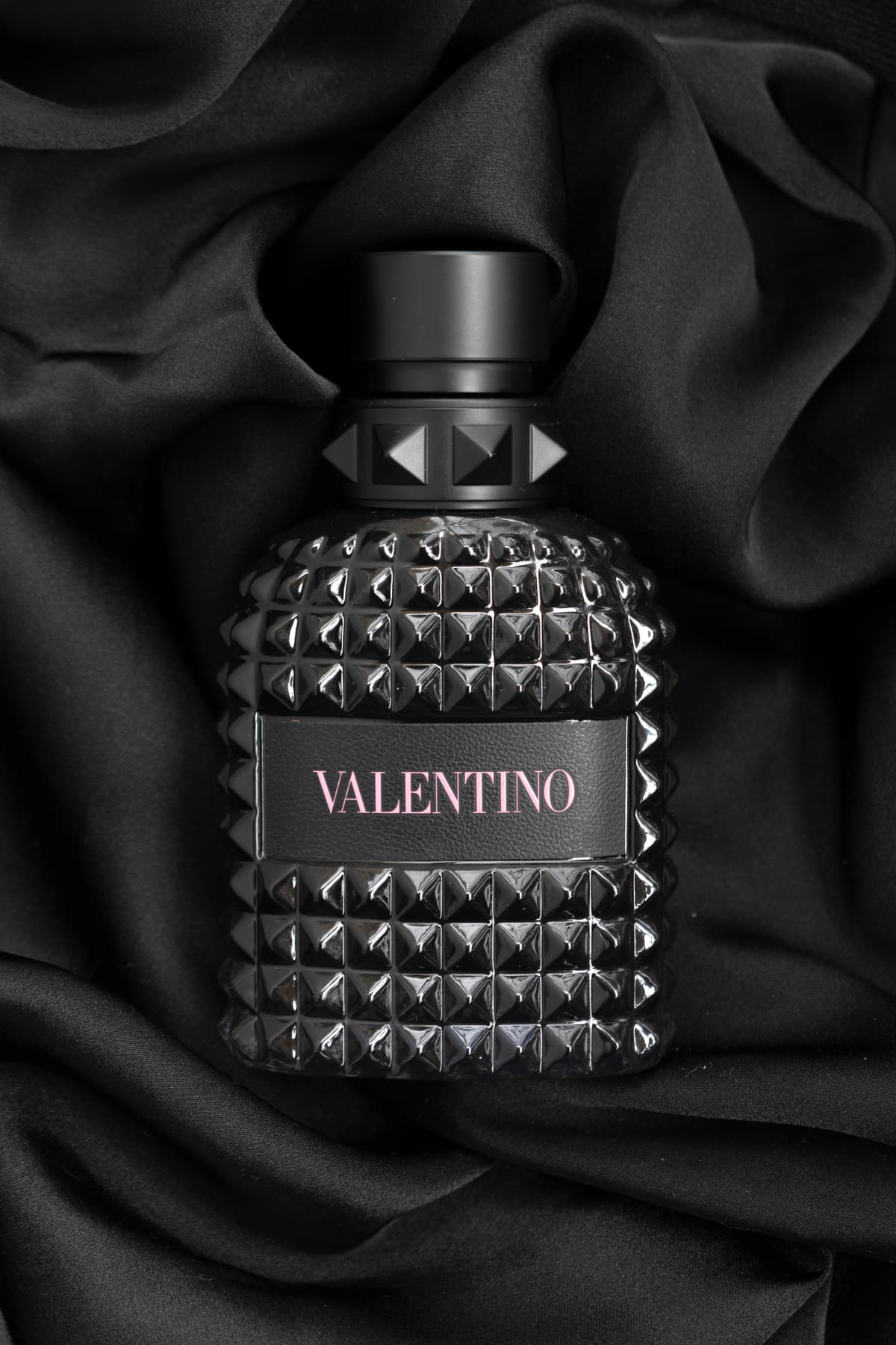 Valentino perfume bottle on black silk